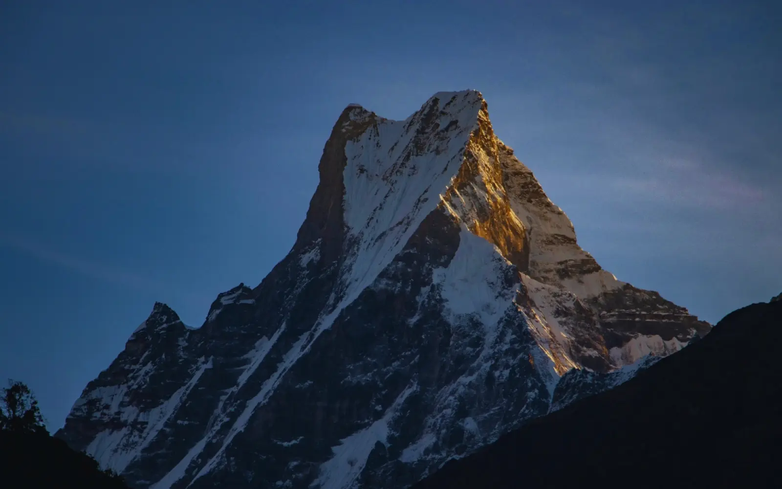 Machhapuchhre mountain fishtail peak in Annapurna region Nepal with snow covered twin summit and clear blue sky