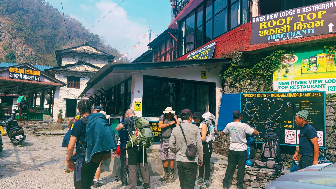 Birethati trailhead entrance with trekkers beginning the route to Annapurna Base Camp