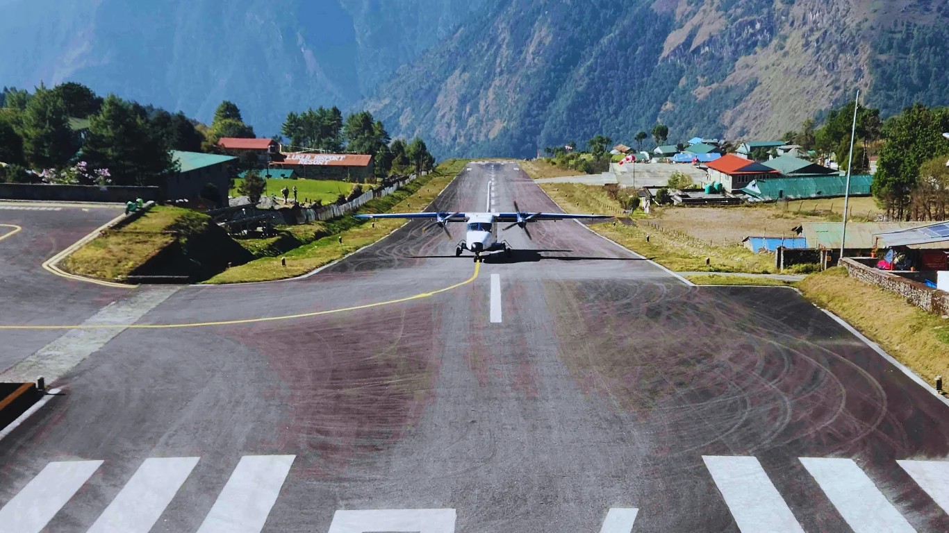 Small aircraft landing at Tenzing Hillary Airport in Lukla at the start of the Everest Base Camp trek in Nepal
