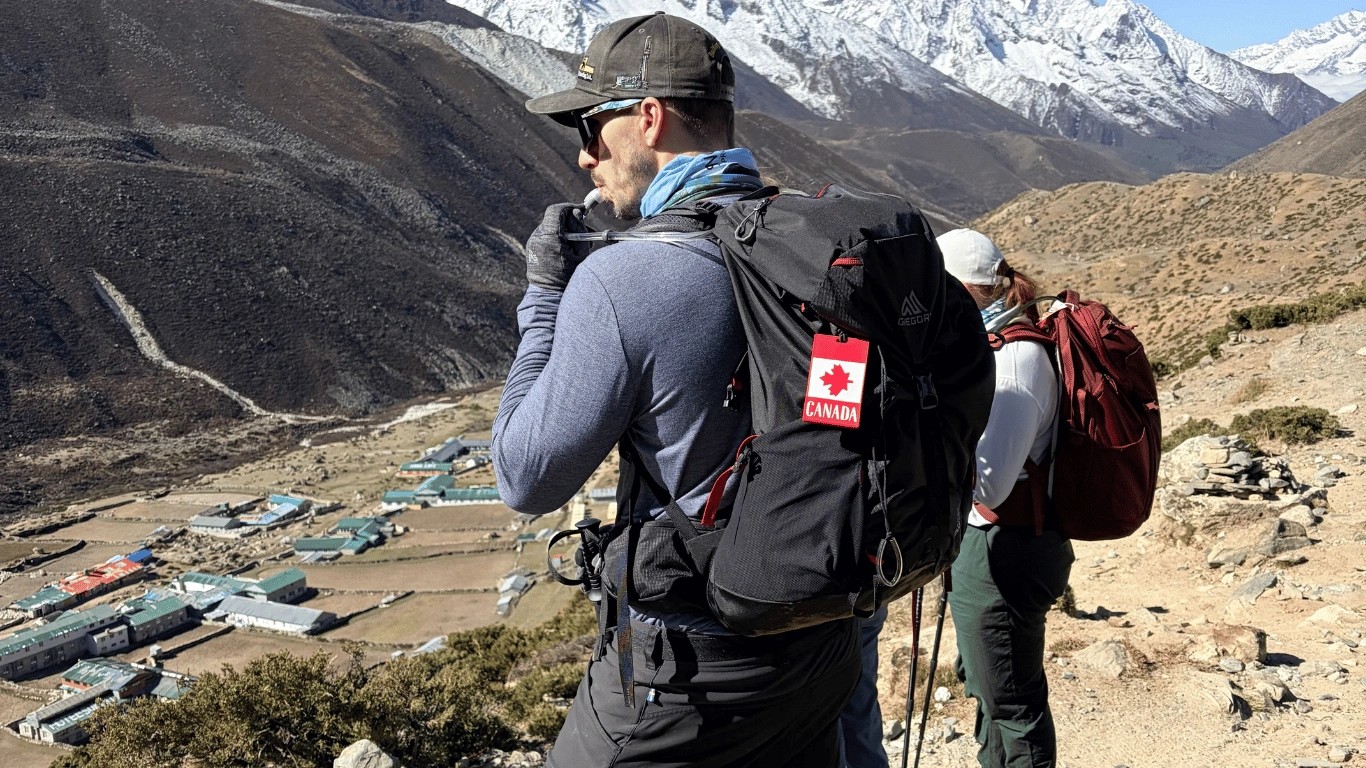 Trekkers take a gradual acclimatization hike while staying hydrated at high altitude.