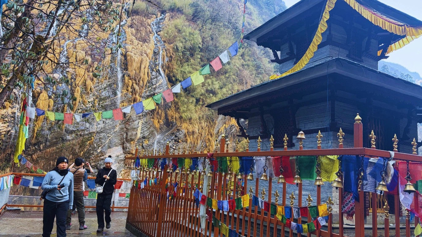 Trekking group photo near sacred temple on Annapurna Base Camp trek in Modi Khola valley