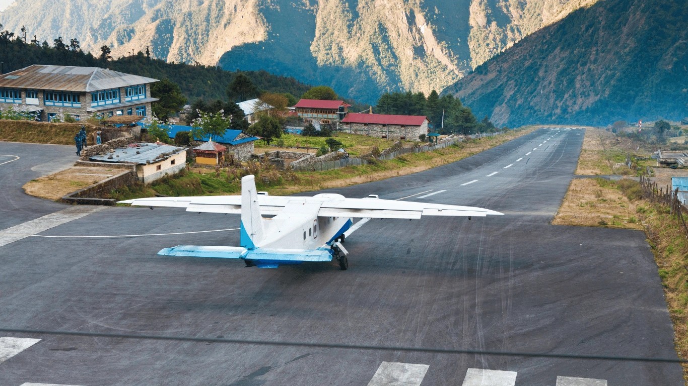 Trekker checking Lukla airline ticket counter for return flight time confirmation solo travelers insider tip Nepal