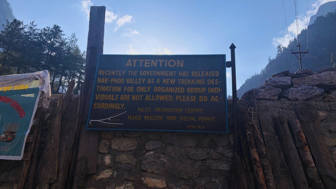 Government rule board highlighting nar phu valley trek cost regulations and mandatory group trekking requirement in restricted area Nepal