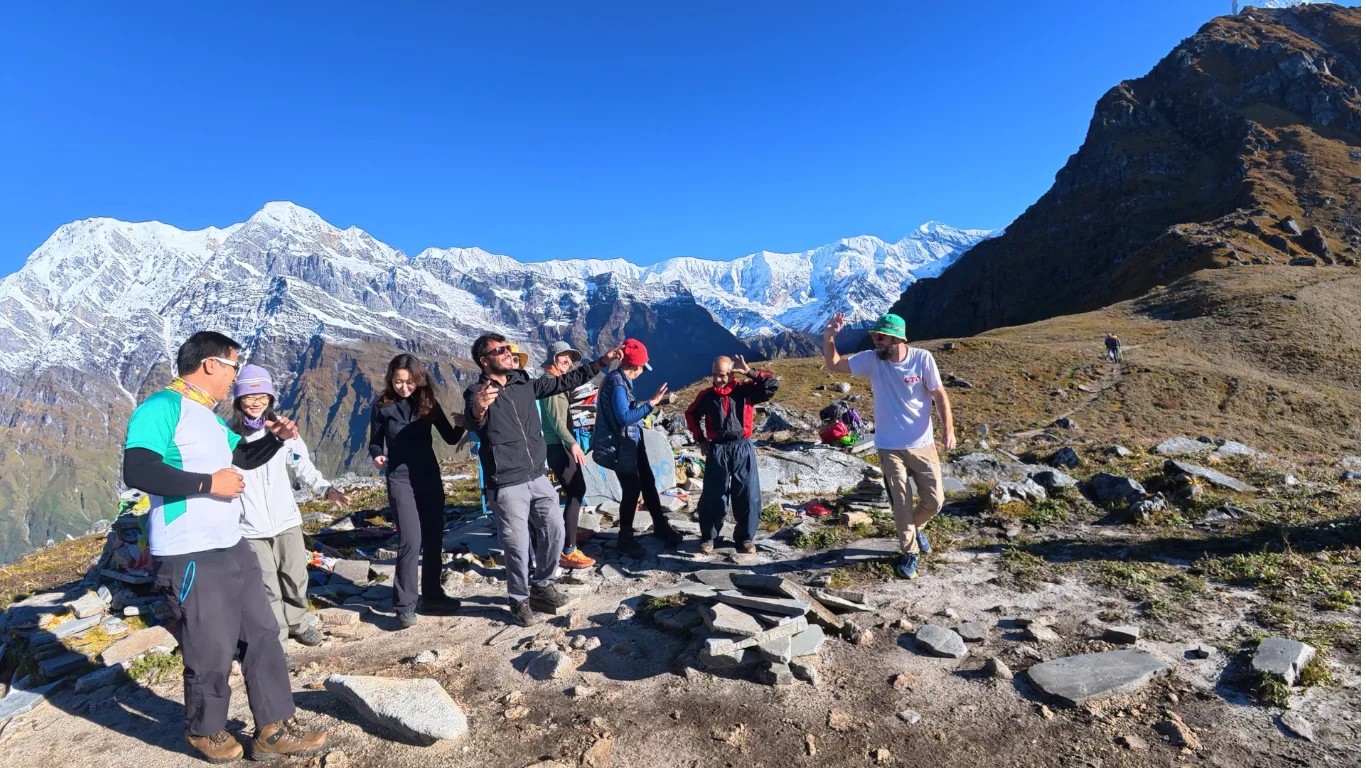 Celebrating at Mardi Himal Base Camp, around 4,500 metres (14,764 feet) above sea level, with the Himalayan peaks rising behind us.