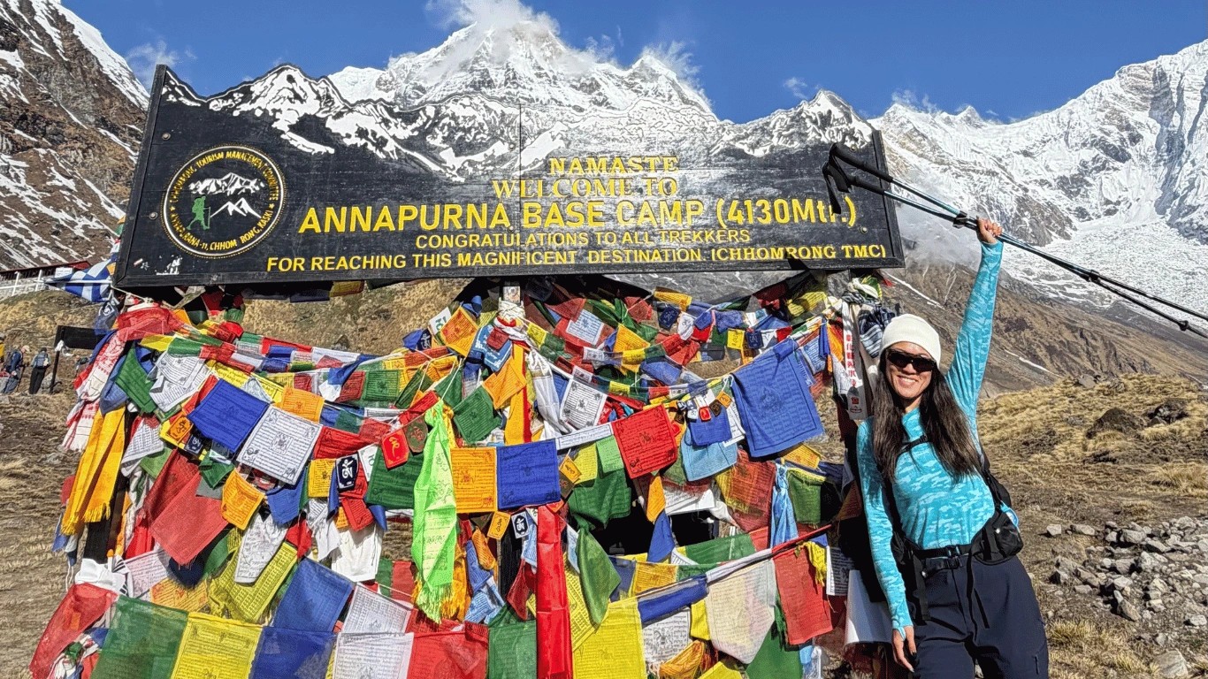 Solo female trekker hiking toward Annapurna Base Camp in Nepal.