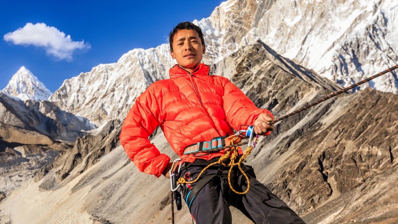 Sherpa mountaineers training on fixed ropes and climbing equipment in preparation for Himalayan expeditions, demonstrating technical climbing skills and safety procedures.