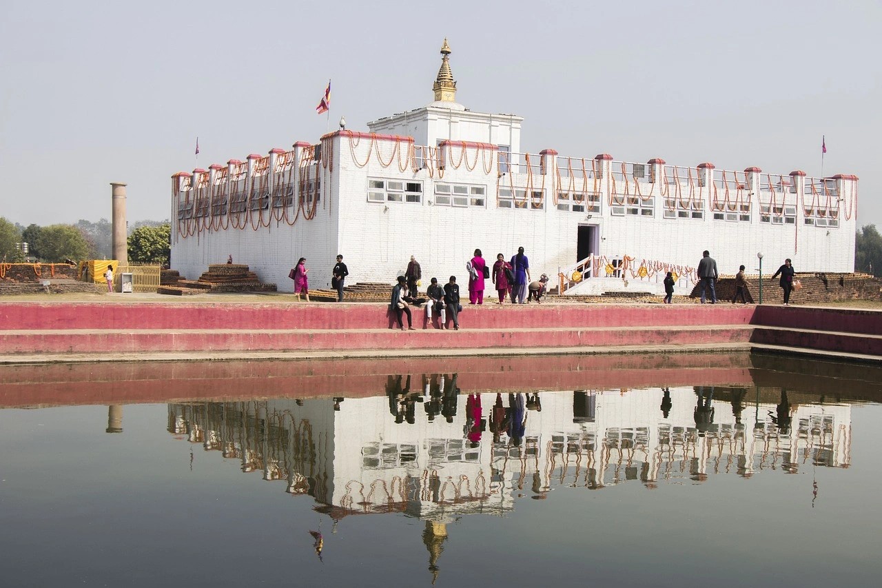 Maya Devi Temple, the main temple in Lumbini, surrounded by peaceful gardens and Buddhist prayer flags, under clear skies.