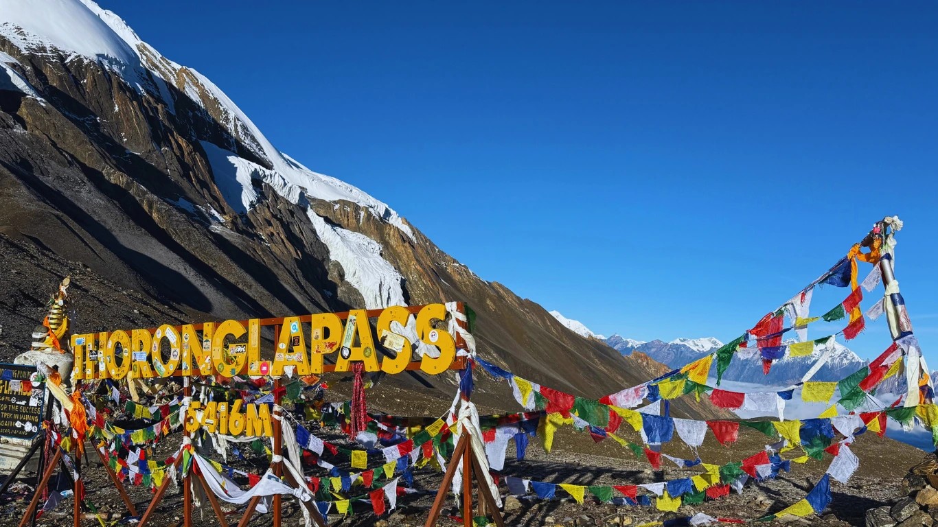 Thorong La Pass signboard marking the high point on the Annapurna Circuit Trek in Nepal.