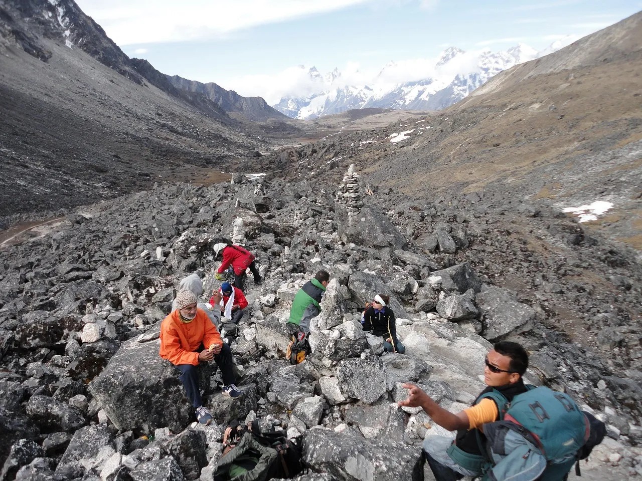 Local guides assisting trekkers during trekking in Nepal, pointing out natural and cultural highlights along the trail.