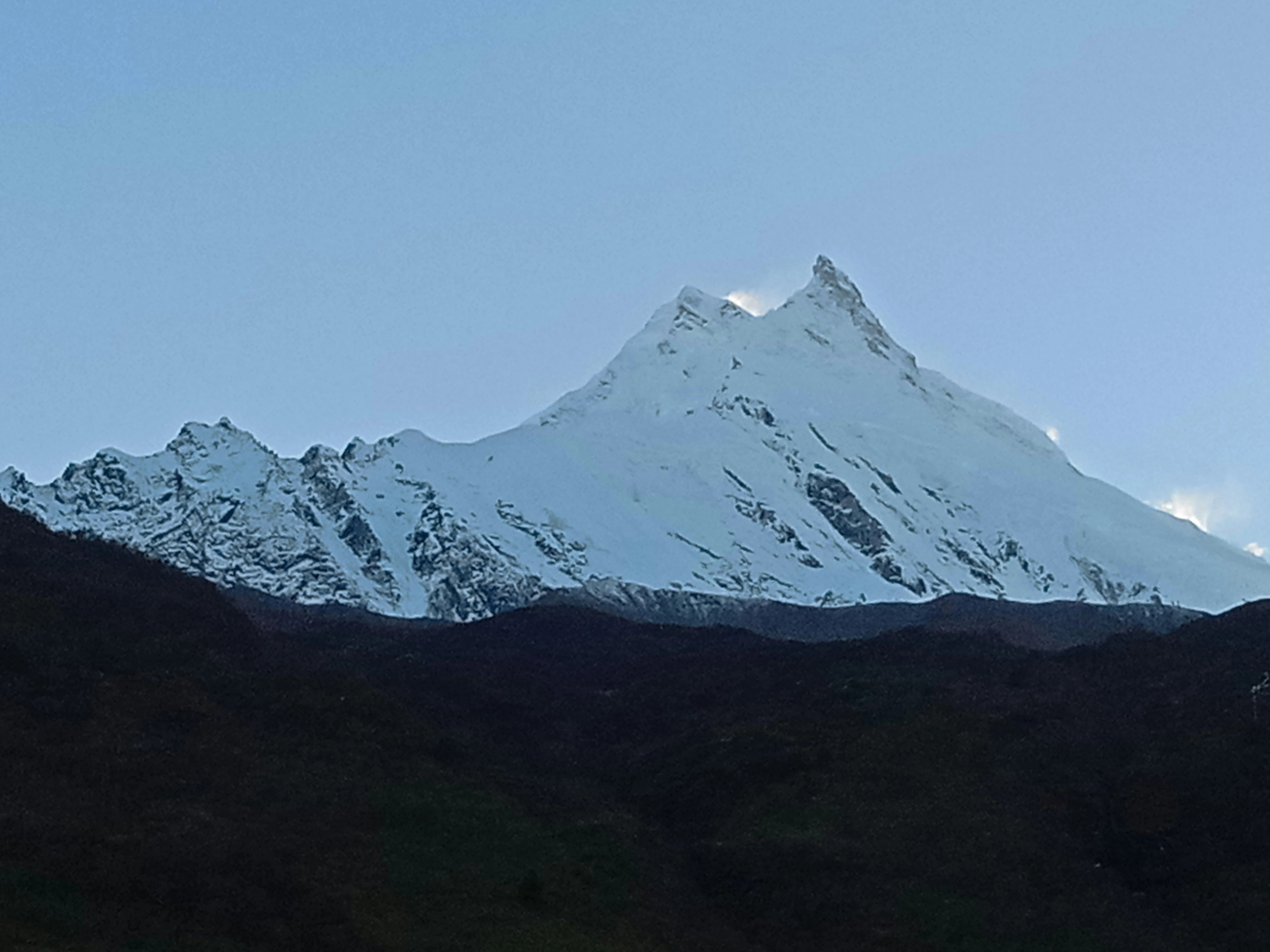 Mount Manaslu peak in Nepal with snow covered summit and dramatic Himalayan landscape.