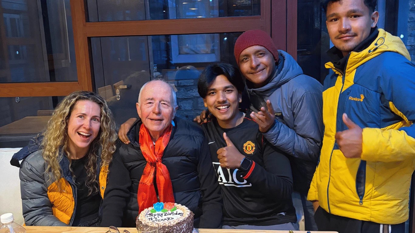 A 68-year-old Annapurna Circuit trekker celebrating his birthday with Majestic Trails Nepal after crossing Thorong La Pass in March 2026.