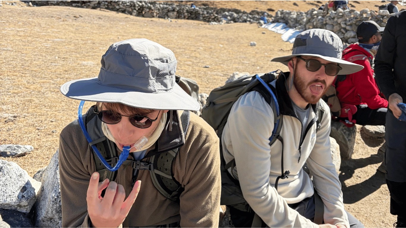 Majestic Trails Nepal guest resting every 20–30 minutes above 4,000 m and drinking water during the trek
