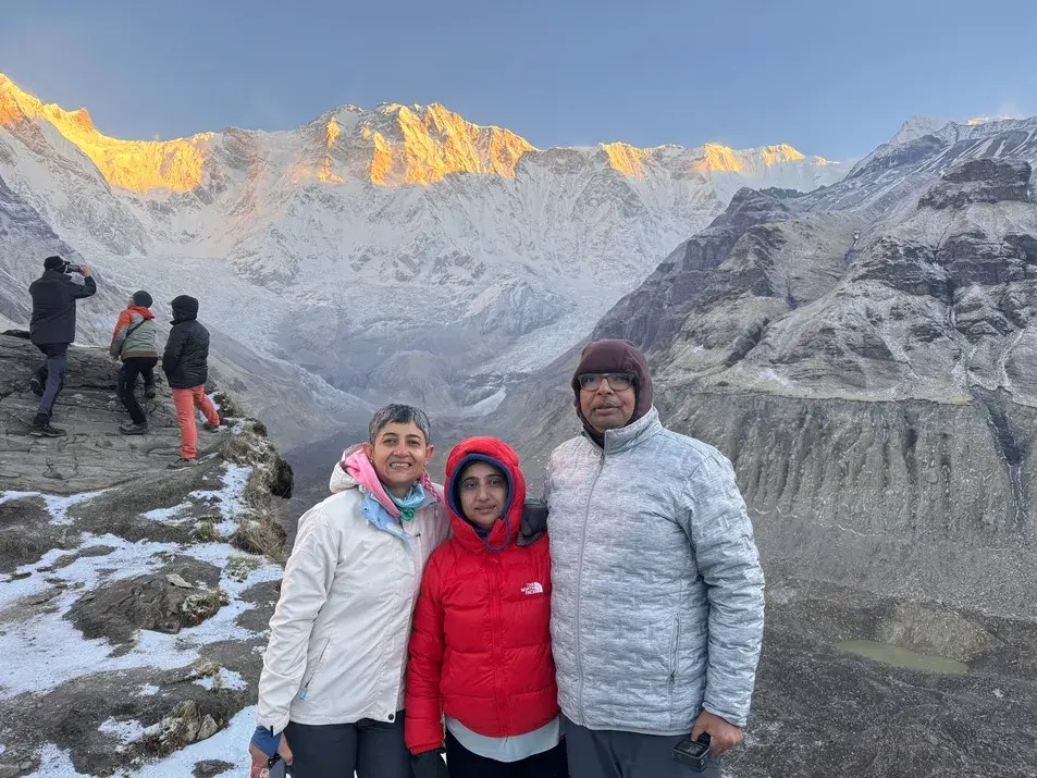 Trekking in Nepal with Annapurna I glowing in the background, showcasing the Himalayan landscape and diverse ecological zones.