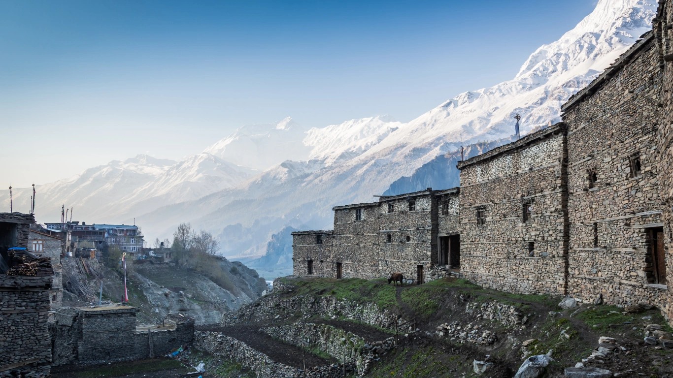 Traditional stone houses in Manang village with Himalayan peaks
