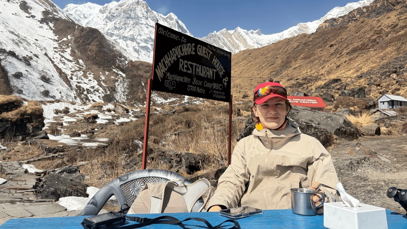 Trekkers resting and drinking water during the Annapurna Base Camp trek to support acclimatization