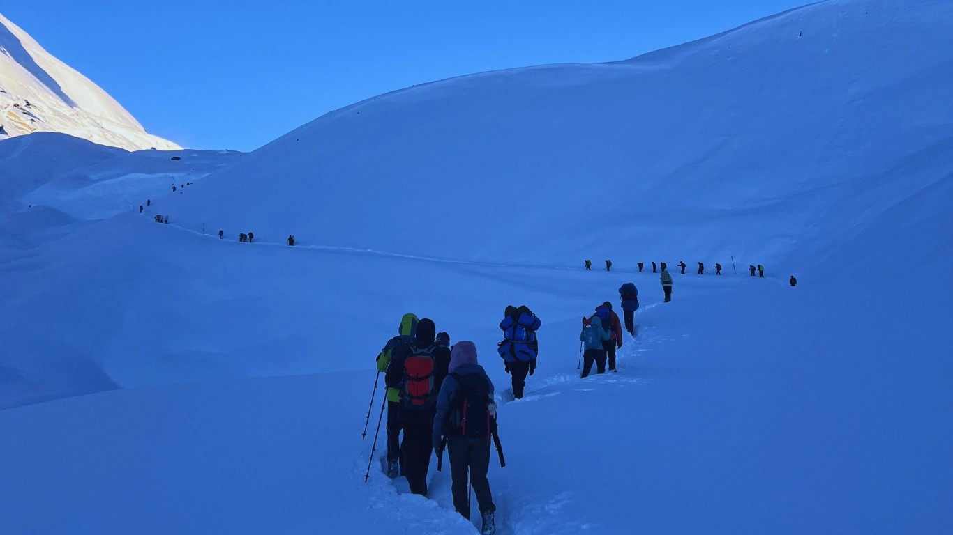 Female trekking guide Nepal Bibisika Raut leading trekkers in heavy snow on the Annapurna Circuit