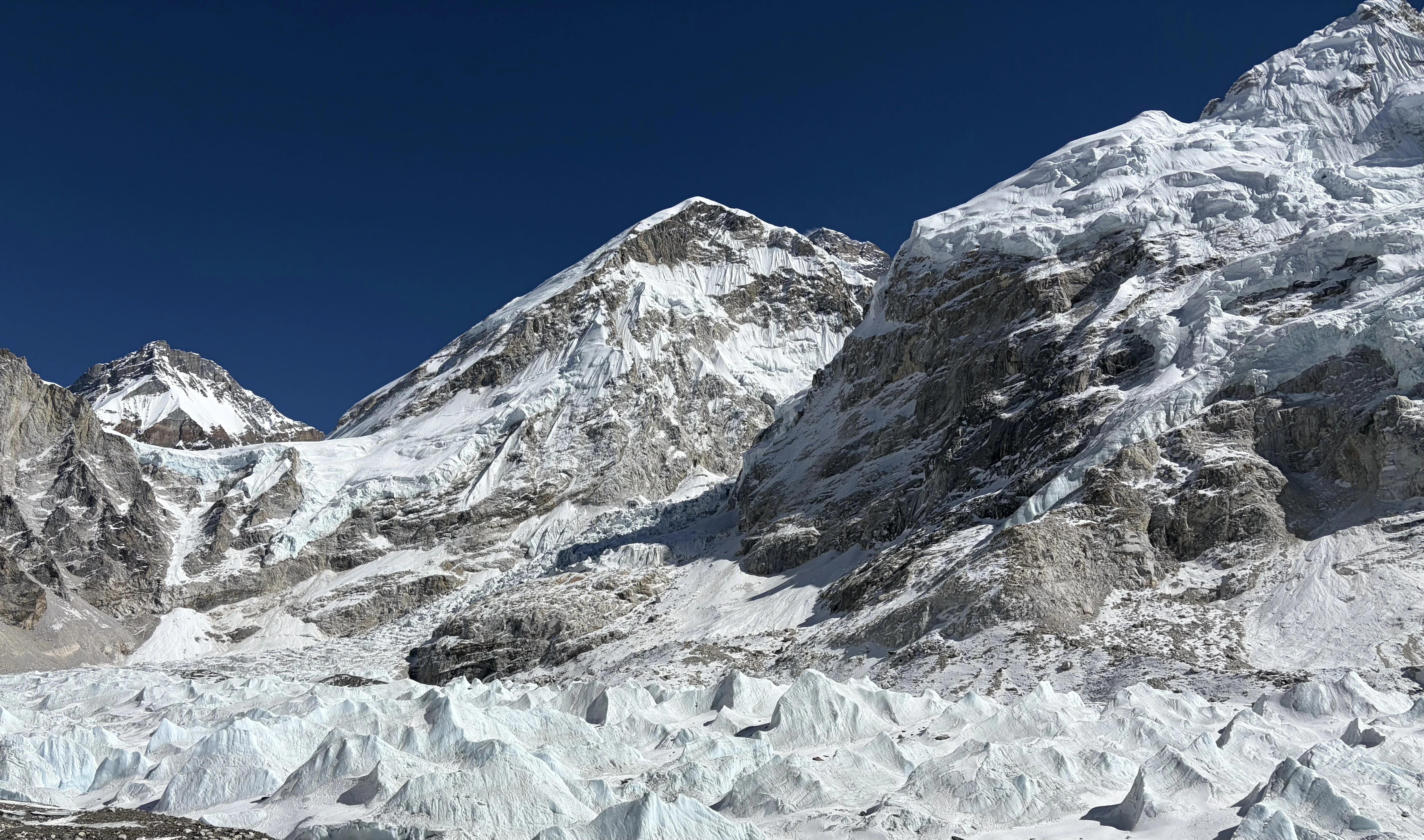 Khumbu Icefall and glacier viewed from Everest Base Camp, showcasing towering ice formations and crevasses beneath the Himalayan peaks