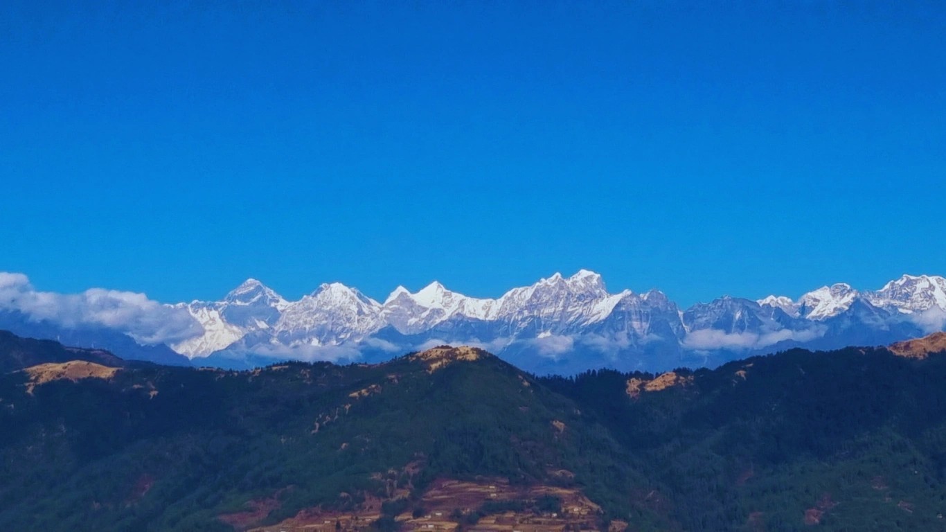 Panoramic Himalayan mountain view from Pikey Peak Trek Nepal showing snow-capped peaks under a clear blue sky