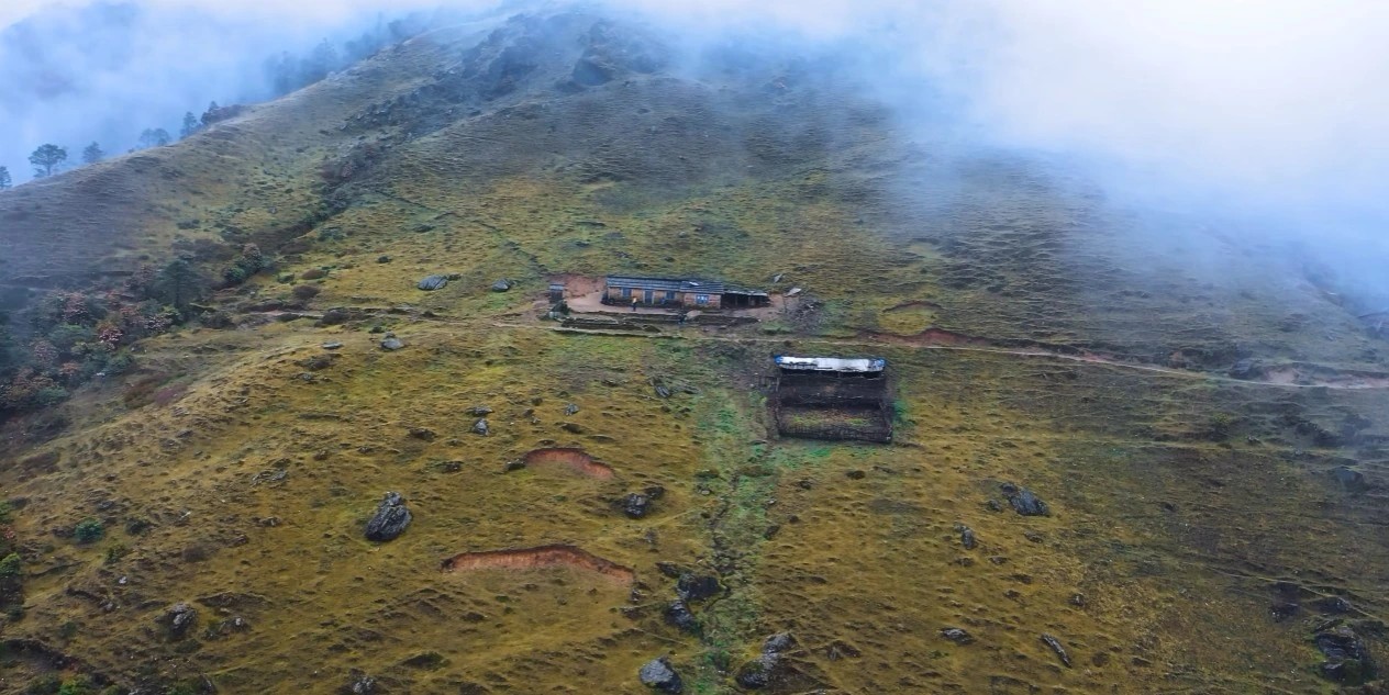 Lush green terraced hills and misty landscape on Pikey Peak Trek during monsoon season