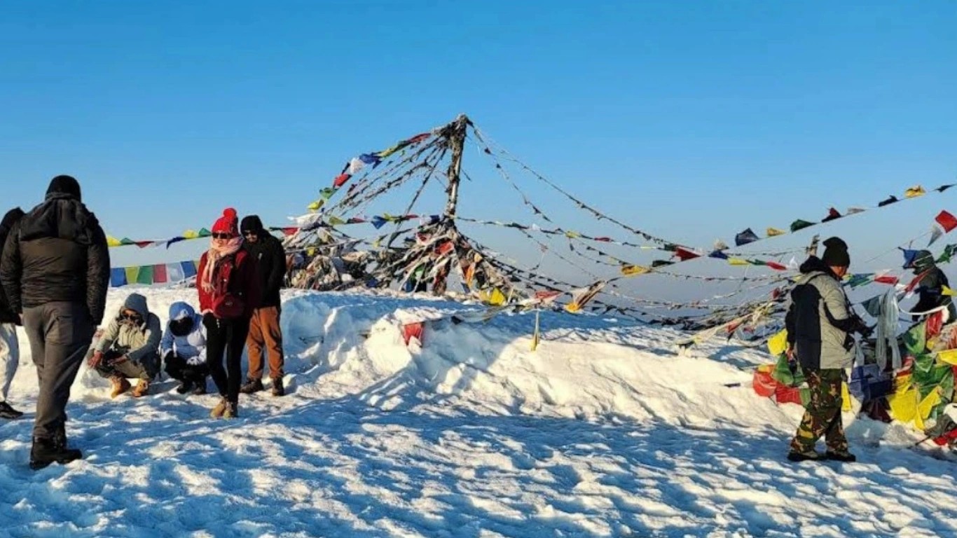 Trekkers celebrating at Pikey Peak summit with Mount Everest panoramic view Nepal moderate trek