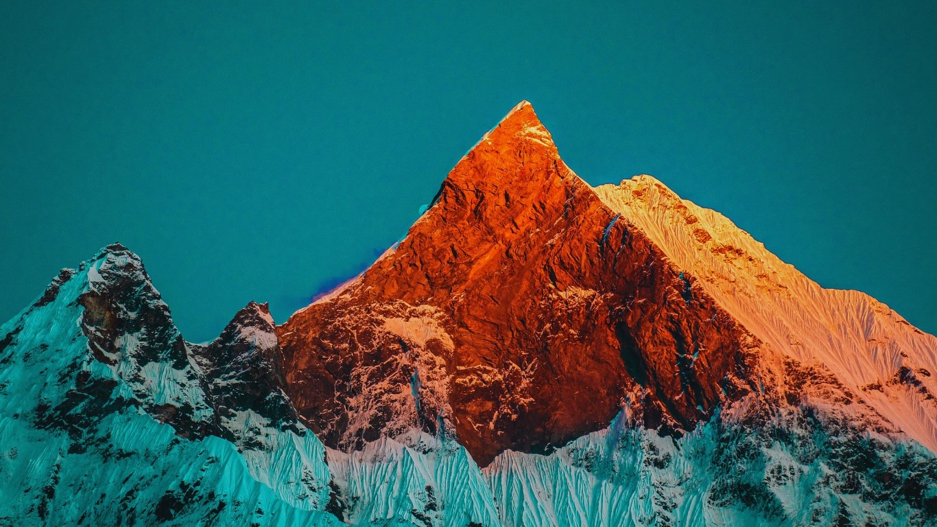 Macchapuchre Fishtail Mountain Nepal rising sharply with its twin summit peaks above the Annapurna Sanctuary on a clear day.