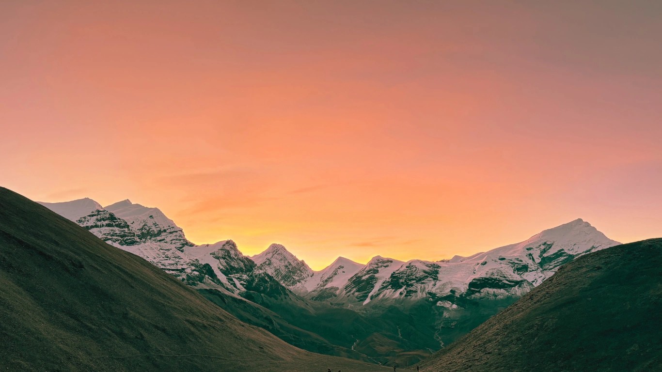 Spectacular golden sunrise illuminating Himalayan peaks during final ascent to Thorong La Pass summit at 5,416m (17,769ft)