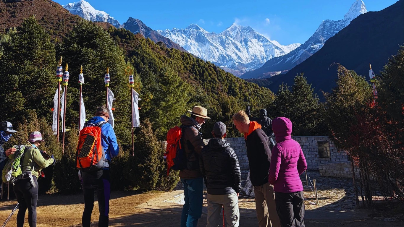 Trekkers walking on a Nepal mountain trail.