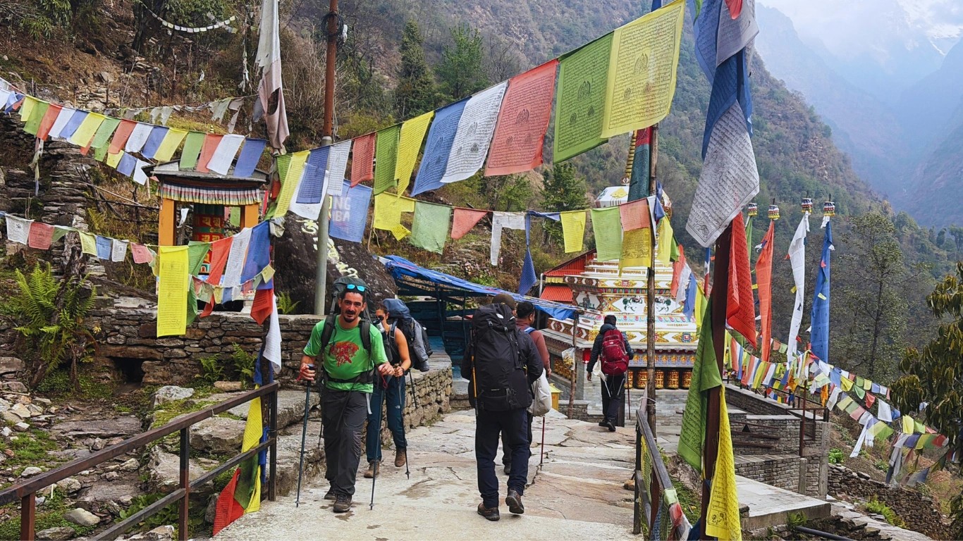 Trekkers climbing stone stairs on the Annapurna trekking trail showing the physical challenge and Annapurna difficulty level.