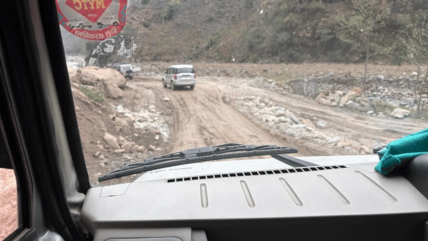 Rough mountain road from Besisahar toward Jagat and Chame on the Annapurna Circuit Trek in Nepal, viewed from inside a jeep.