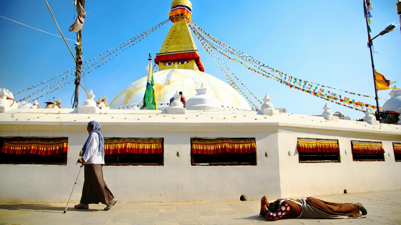 Visitors walking around Boudhanath Stupa in Nepal
