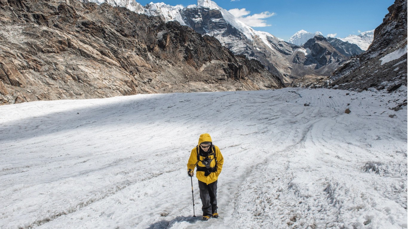 Trekkers walking across a high mountain pass during the Everest region.