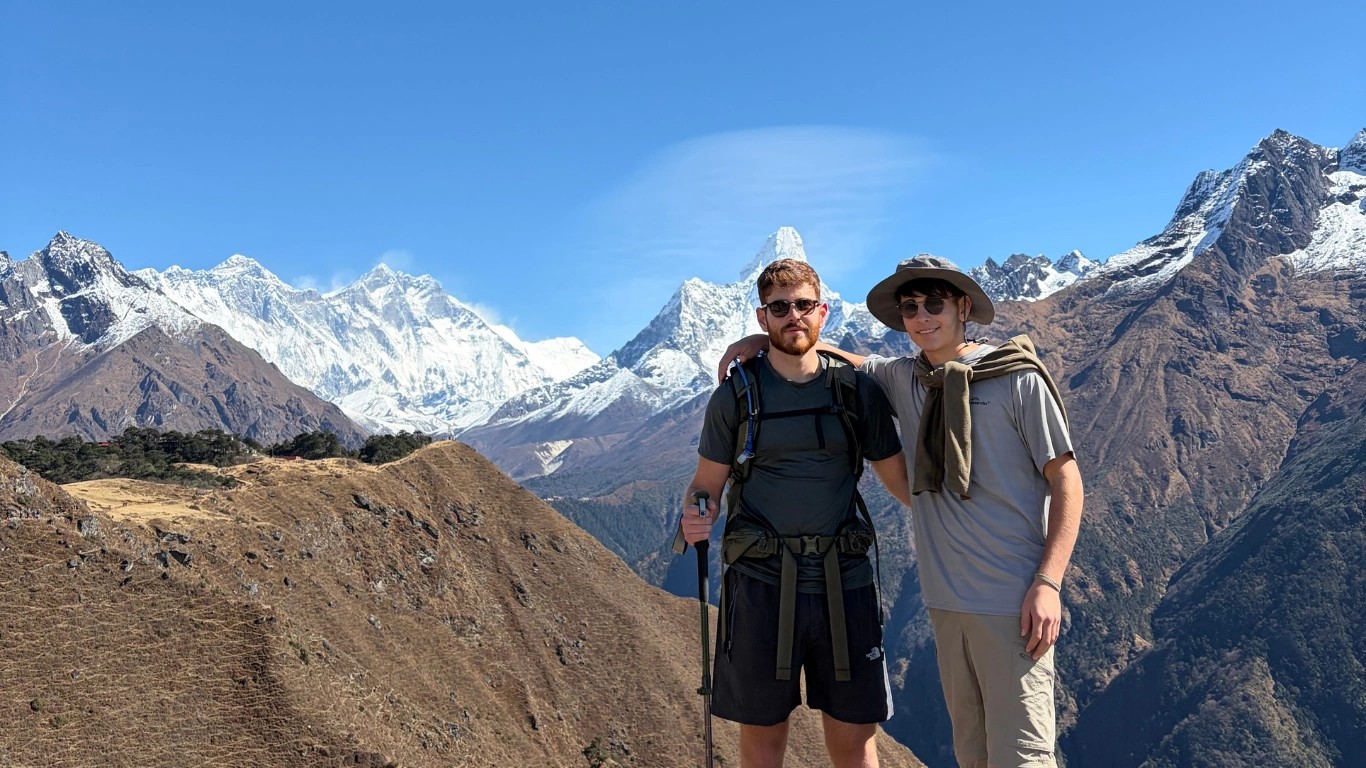 Two brothers posing near Everest View Hotel with Mount Everest in the background during the Everest Panorama Trek in Nepal.