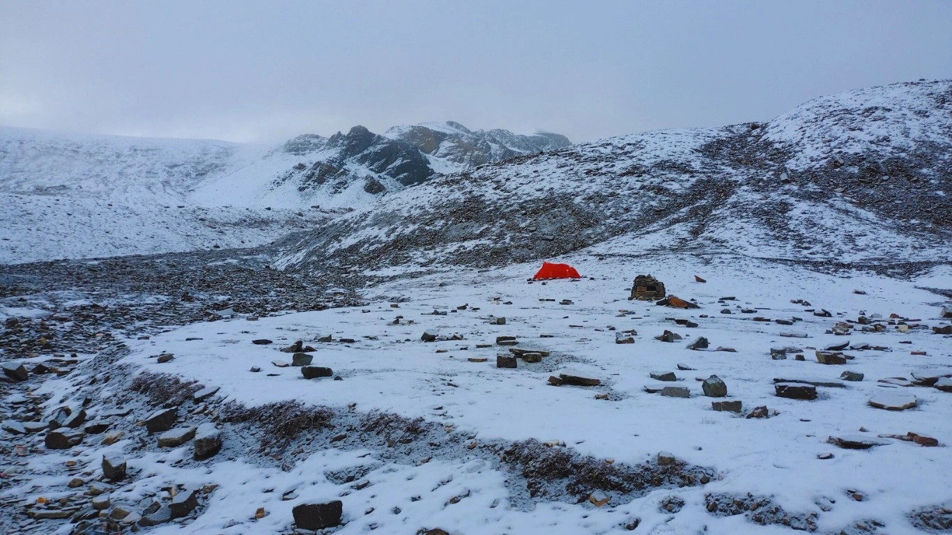 Snow-covered Dhaulagiri Trail winding through the Himalayas during a Nepal trek.