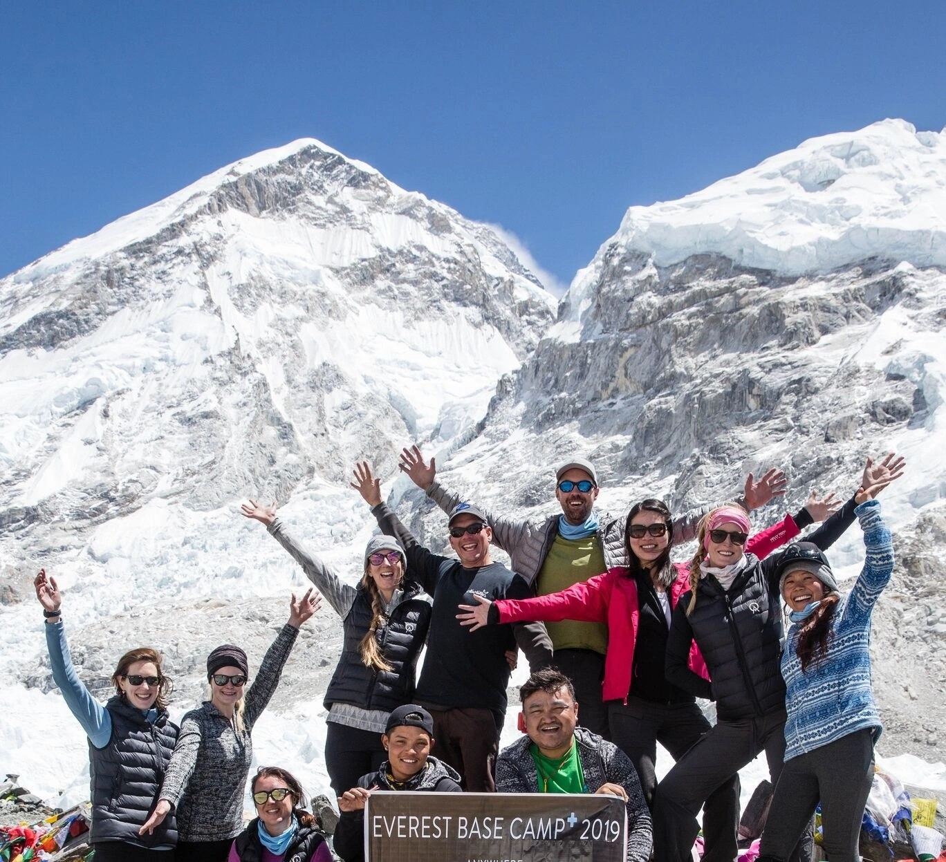 Group of ordinary Majestic Trails Nepal trekkers at Everest Base Camp successful completion different ages backgrounds