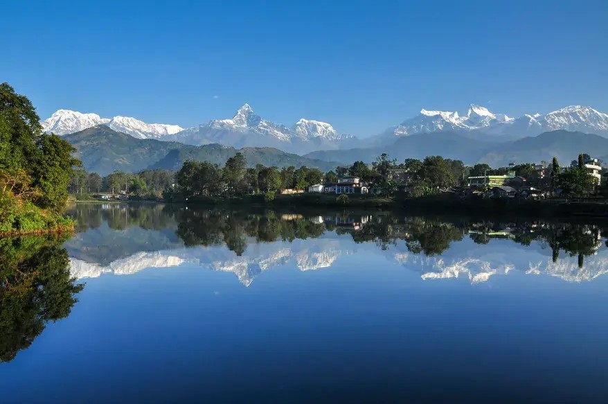 Reflection of the Annapurna ranges on the calm waters of Phewa Lake in Pokhara