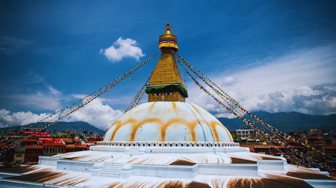 Boudhanath Stupa UNESCO heritage site Nepal giant Buddhist stupa with prayer flags and monks walking around
