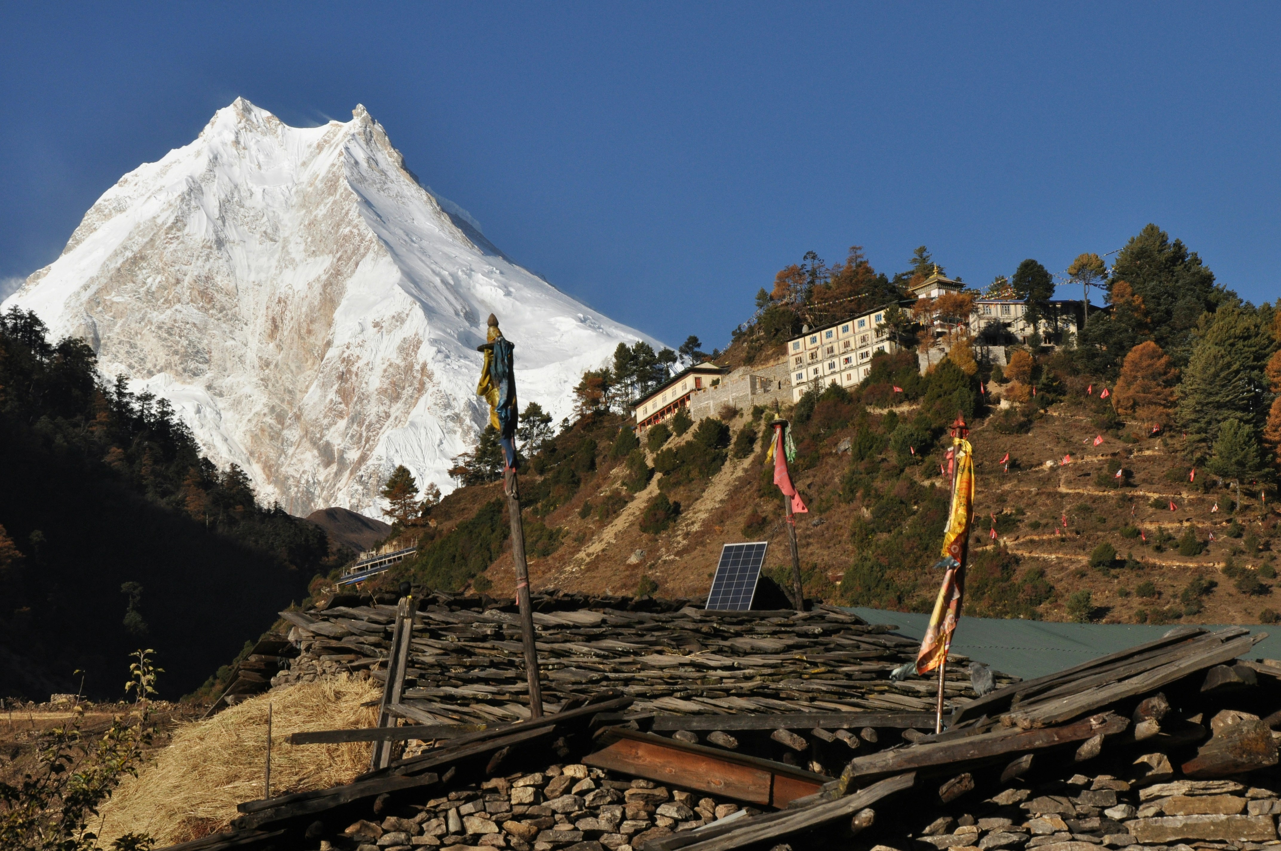 Panoramic view of Manaslu towering over a Himalayan village, MCT Trek Nepa