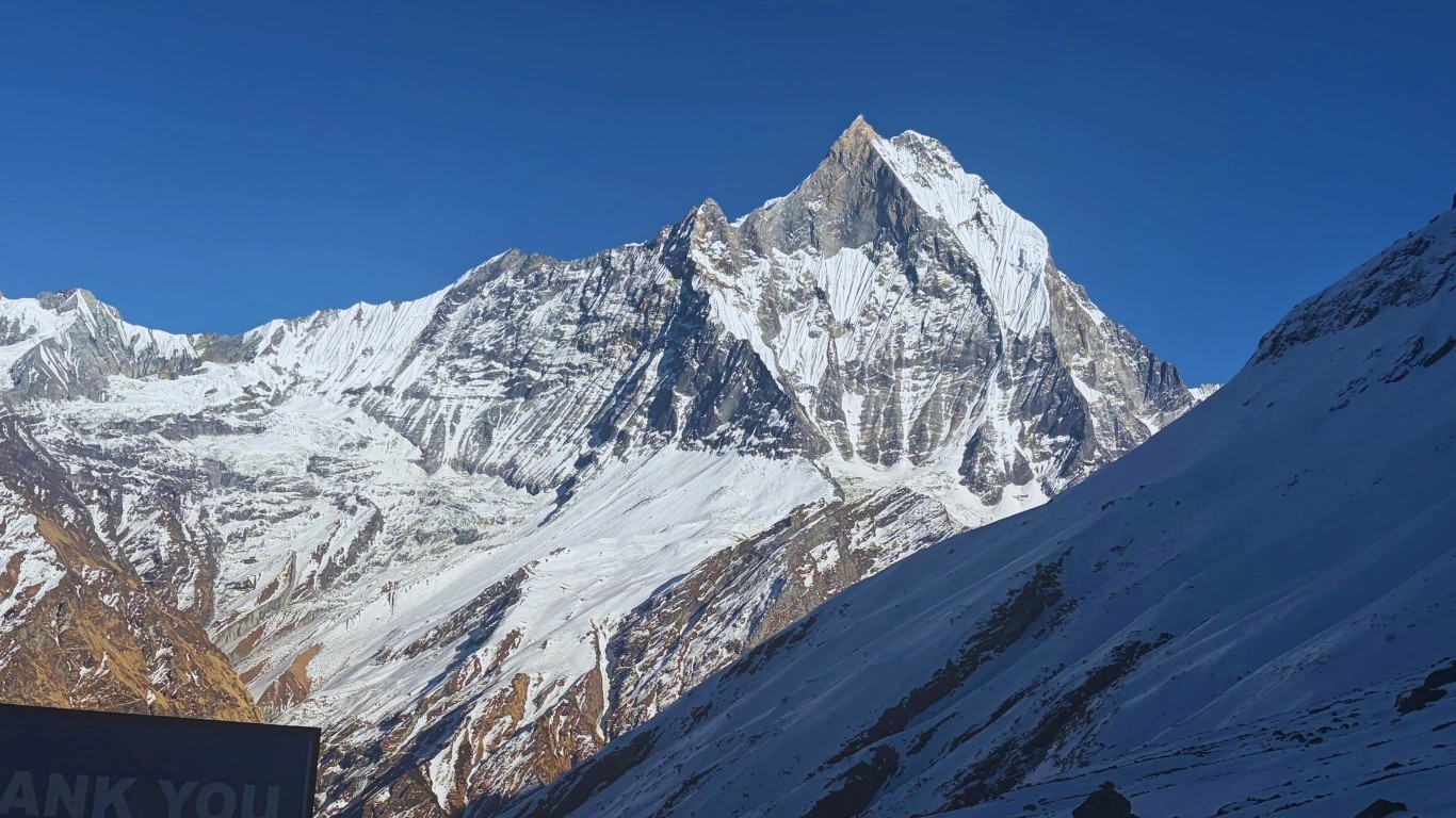 Machapuchare peak glowing in soft evening light before sunset near Annapurna Base Camp.