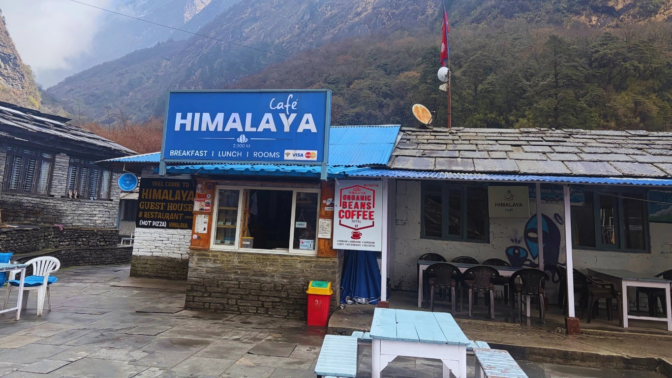 Exterior view of a teahouse lodge in Himalaya with a small window used for ordering tea and coffee along the Annapurna Base Camp Trek.