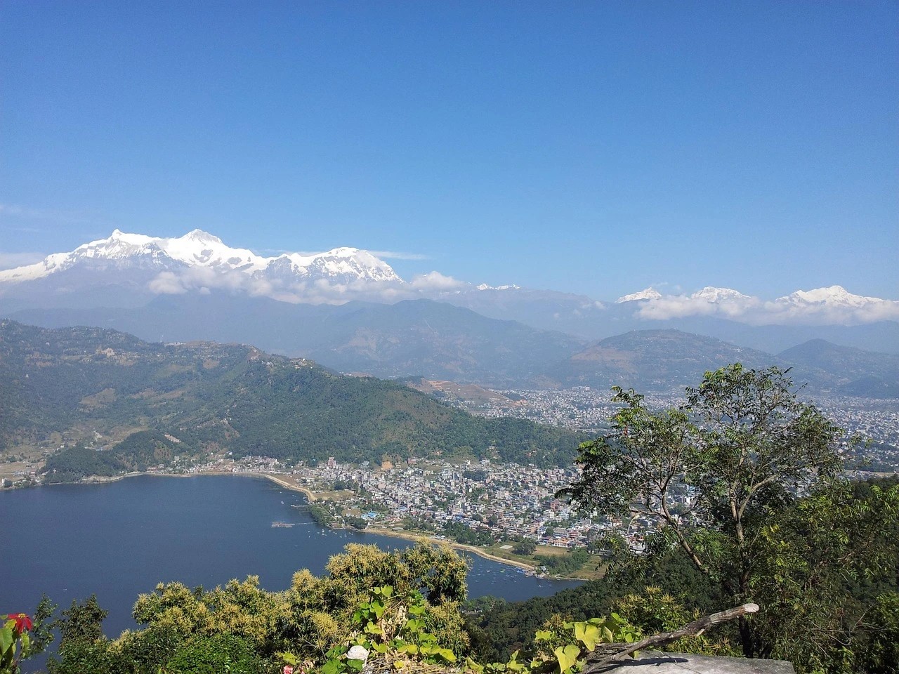 Panoramic view of Pokhara city, Phewa Lake, and Annapurna mountain ranges in Nepal from a hilltop vantage point
