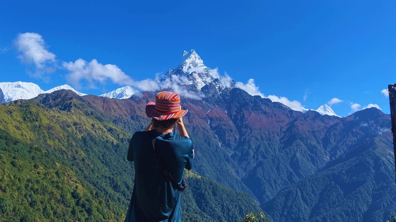 Trekker taking a photo of Mount Fishtail during the trek