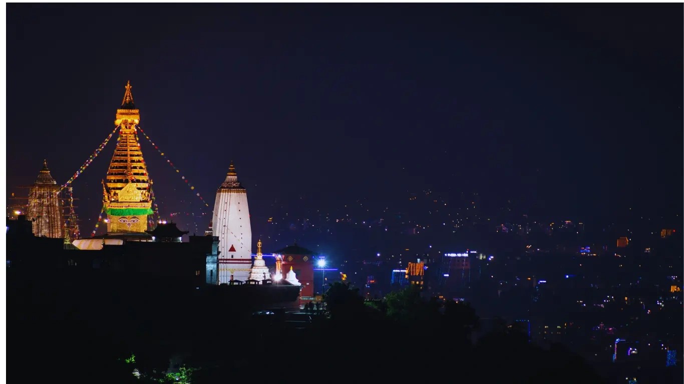 "Night view of Swayambhunath Stupa (Monkey Temple) lit up in Kathmandu, Nepal, perfect for photography and cultural tours."