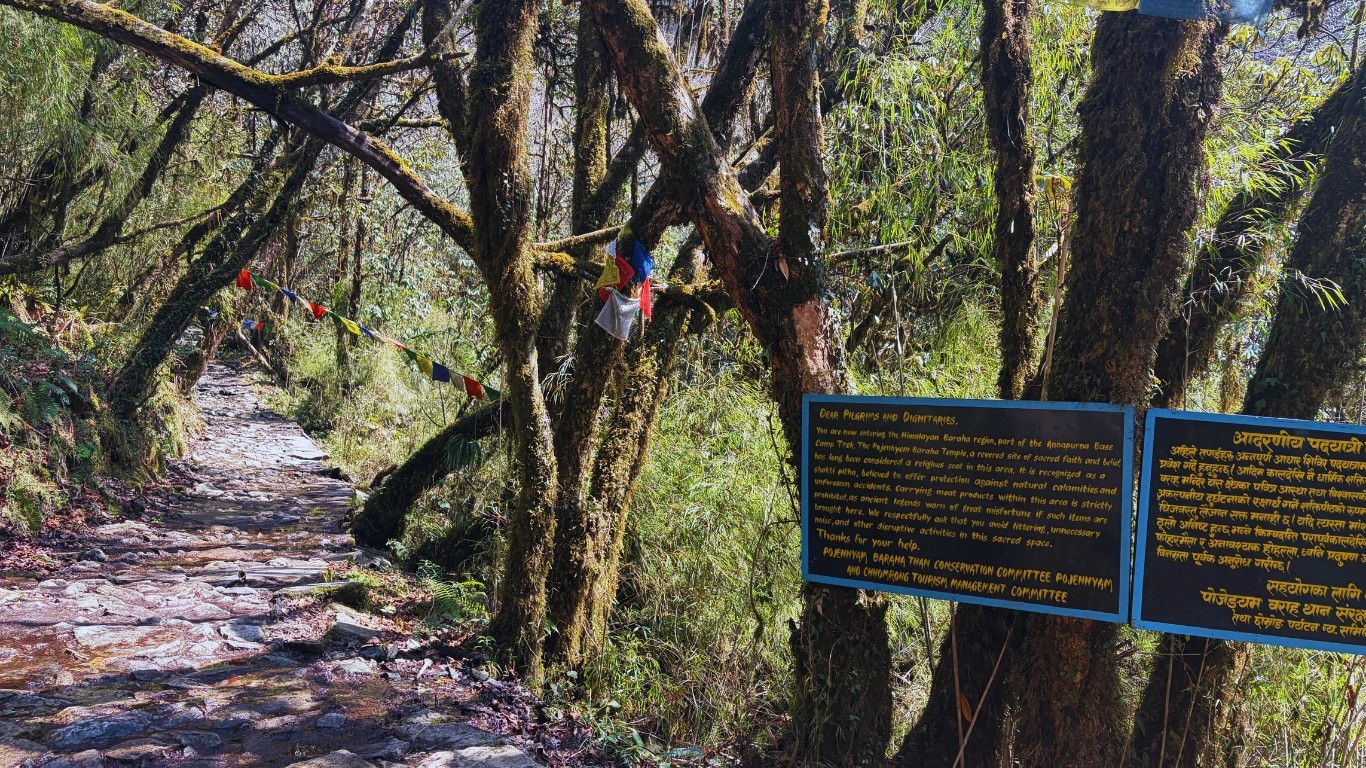 Signboard marking the entrance to Pojenhyam Temple on the Annapurna Base Camp trek in Modi Khola valley