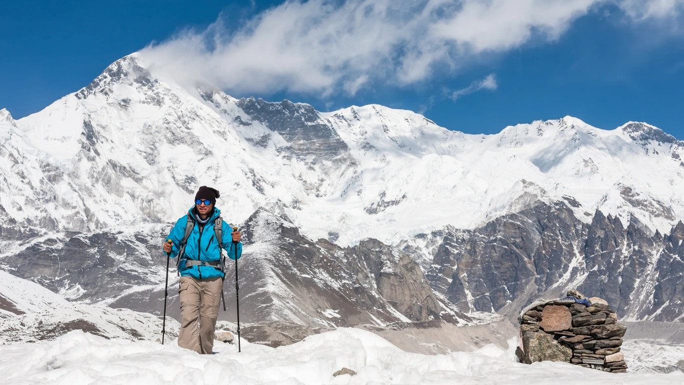 Male trekkers hiking across snowy trails during the non-technical Everest Base Camp Trek.
