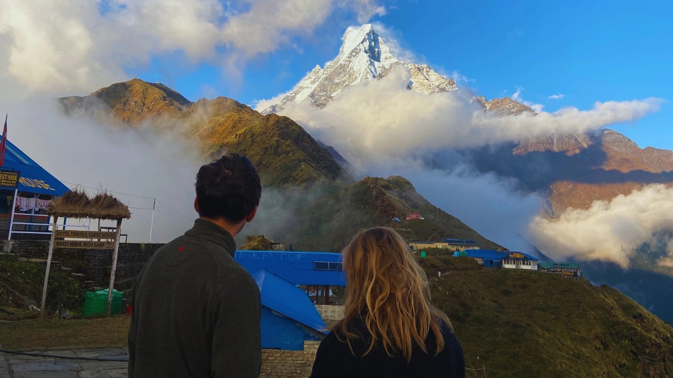 Couple standing together watching Machapuchare peak during the Mardi Himal Trek in Nepal.