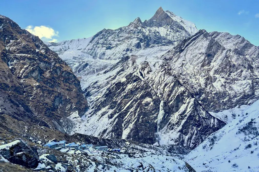 Macchapuchre Base Camp at 3,700 meters on the Annapurna Base Camp trek route, with Macchapuchre Fishtail Mountain rising steeply above the trail in the Annapurna region of Nepal.