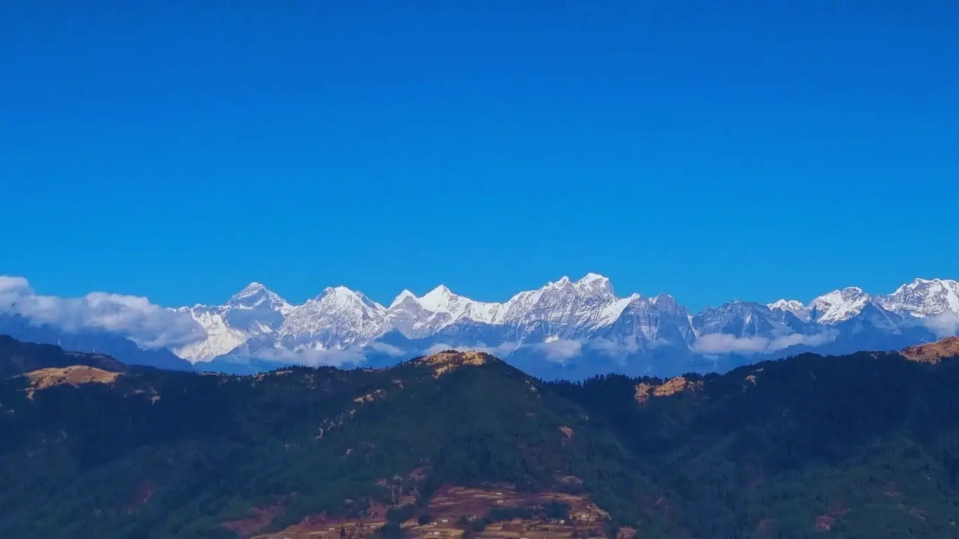 Panoramic Himalayan mountain view from Pikey Peak Trek Nepal showing snow-capped peaks under a clear blue sky.