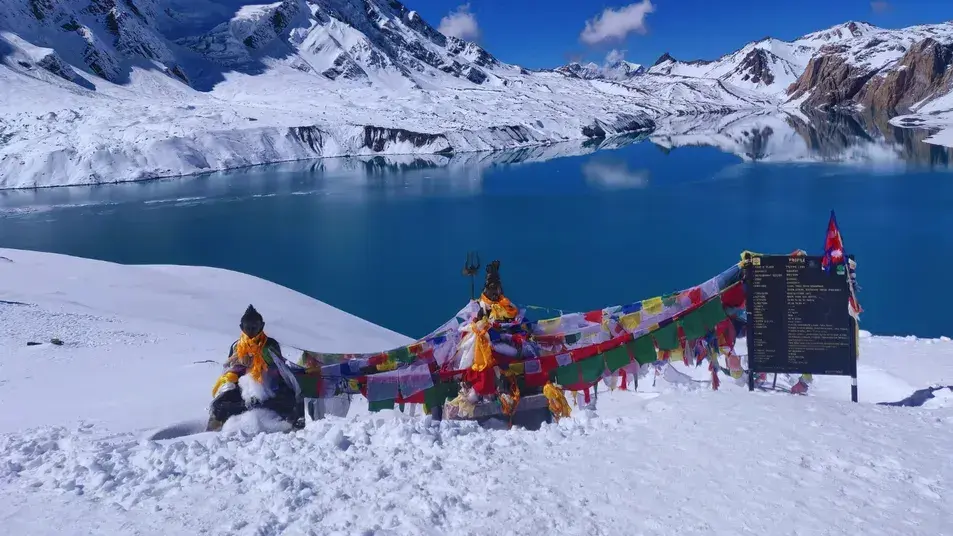 Tilicho Lake with Buddhist prayer flags and Buddha statue, Annapurna region, Nepal lake trek.