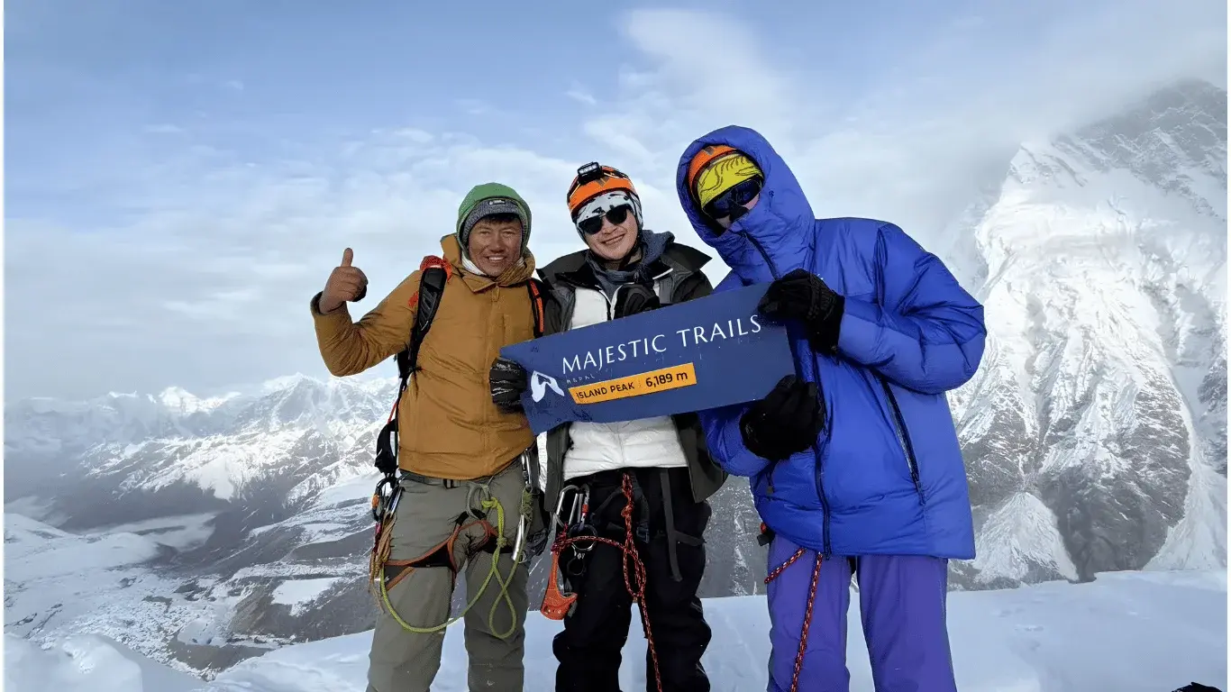 Our trekking group at the summit of Island Peak (6,189m) with an experienced local guide in Nepal.